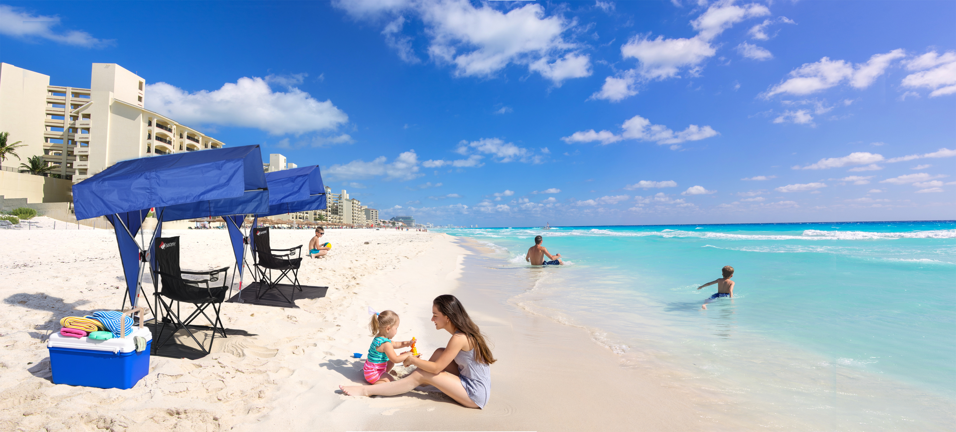 Bandanna Shade deployed on a white sand beach in Cancun, family enjoying the water